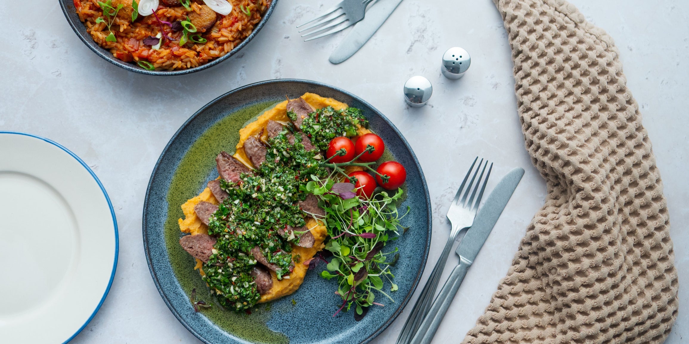 Steak & butter sausage with sweet potato mash & chimichurri sauce