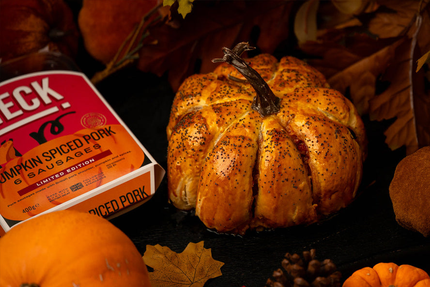 HECK! Pumpkin Spice Sausage Roll shaped like a pumpkin, golden and flaky with poppy seeds on top